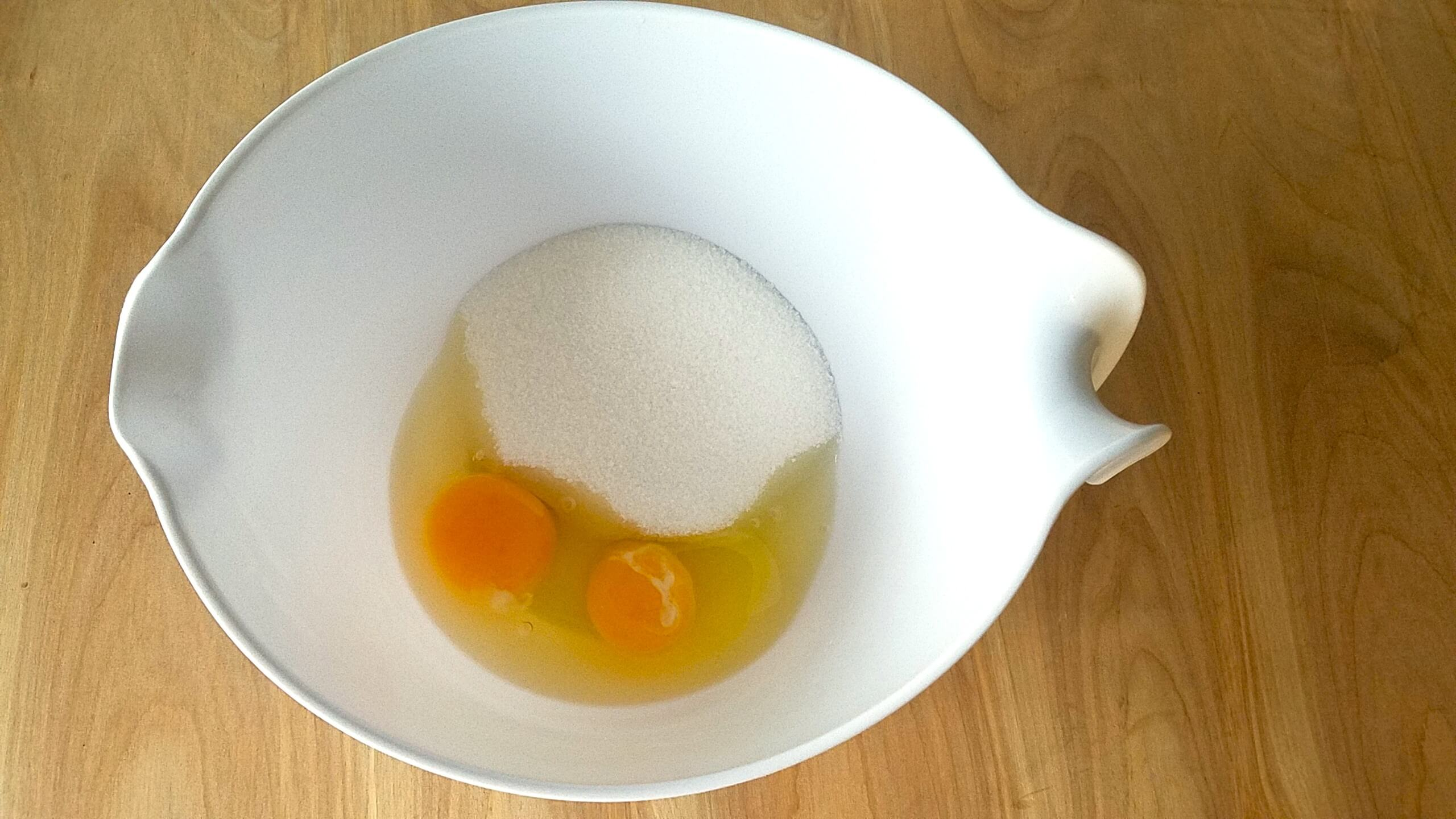 Eggs, sugar, oil, vanilla, and milk whisked together for the cake batter.