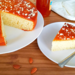 Moroccan apricot cake topped with apricot jam and chopped almonds.