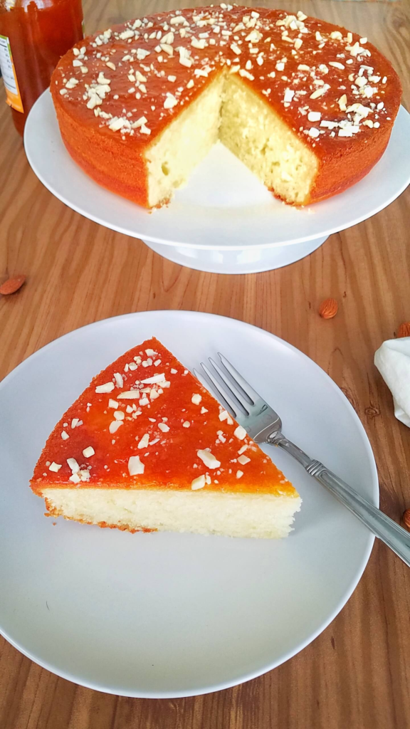 Homemade Moroccan apricot cake with a soft crumb, apricot jam, and chopped almonds.