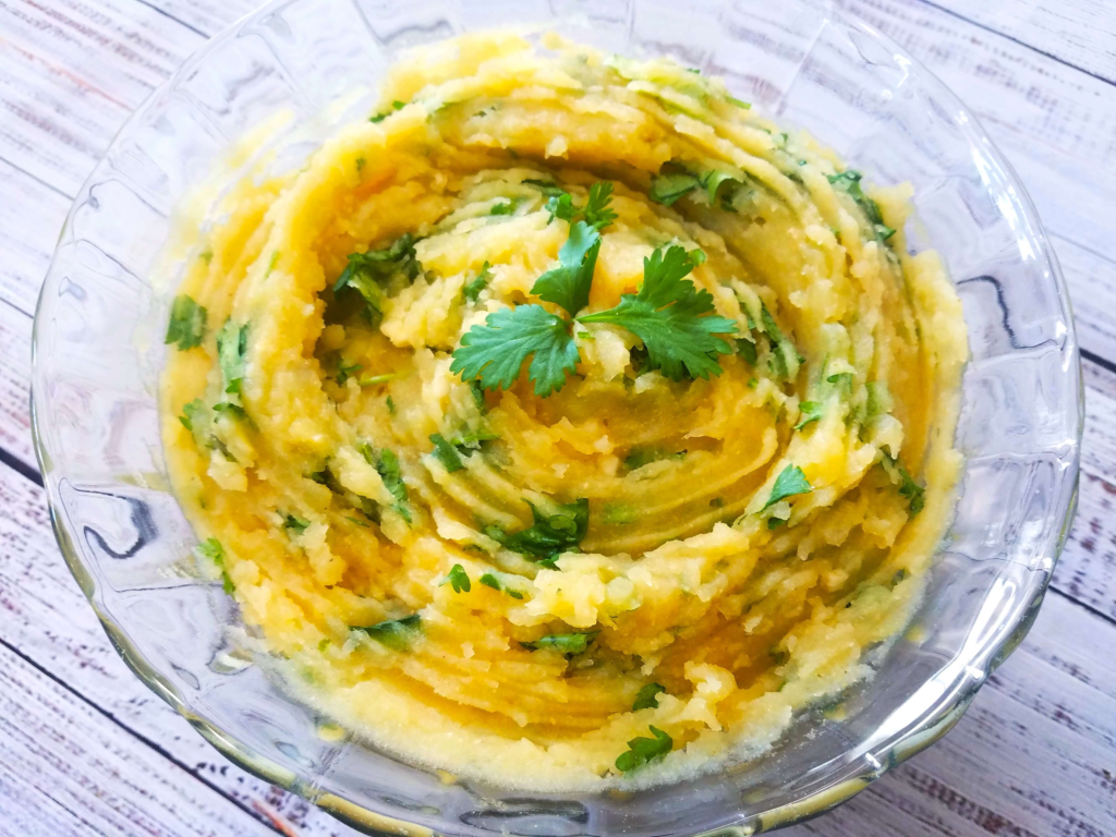 Creamy no mayo mashed potato salad with lemon, cilantro, garlic, and cumin.