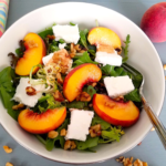 Peach feta salad with juicy peaches, feta cheese, walnuts, arugula, and fresh mint