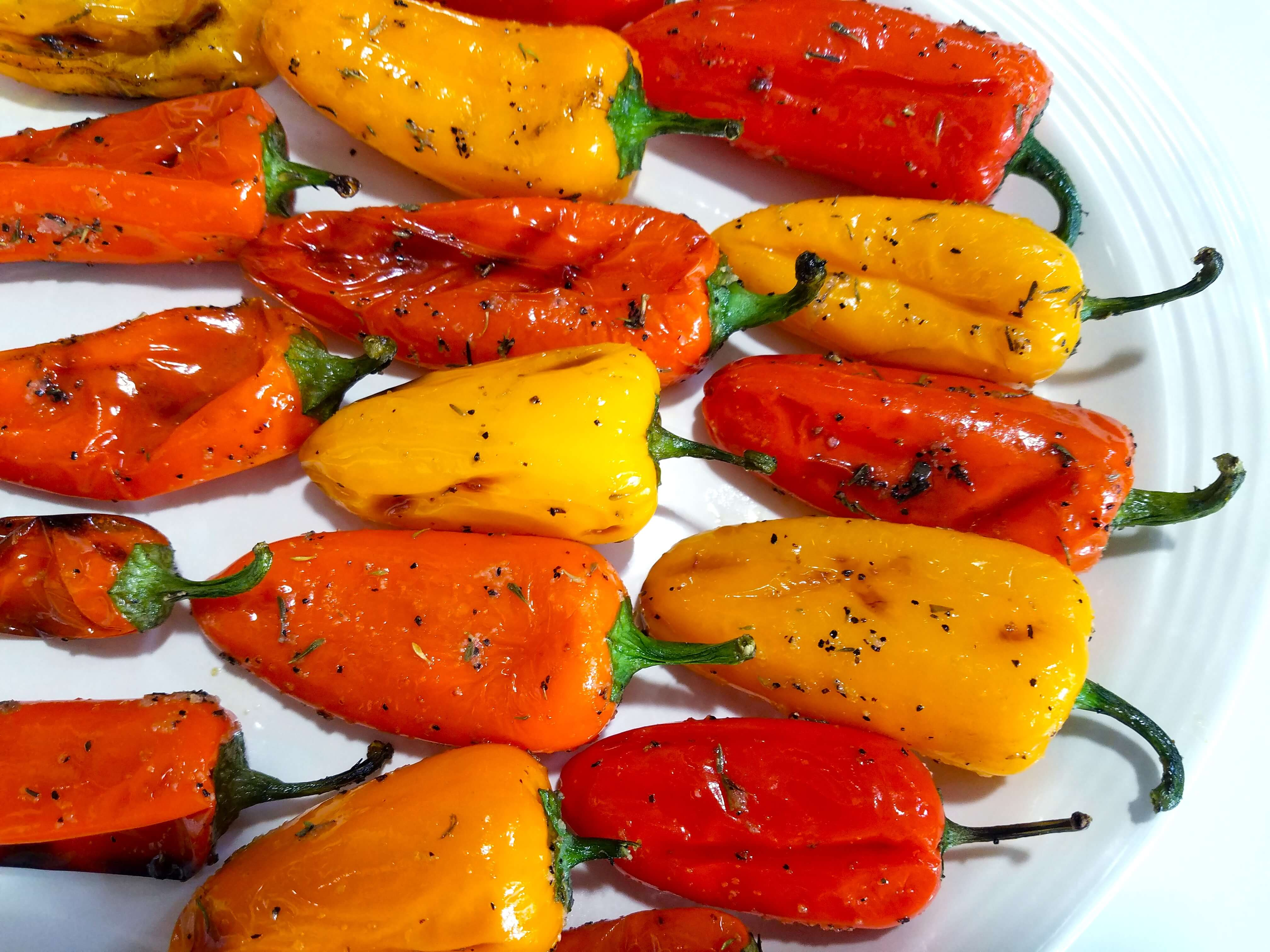Tender grilled mini peppers with beautifully blistered and charred skins served on a platter