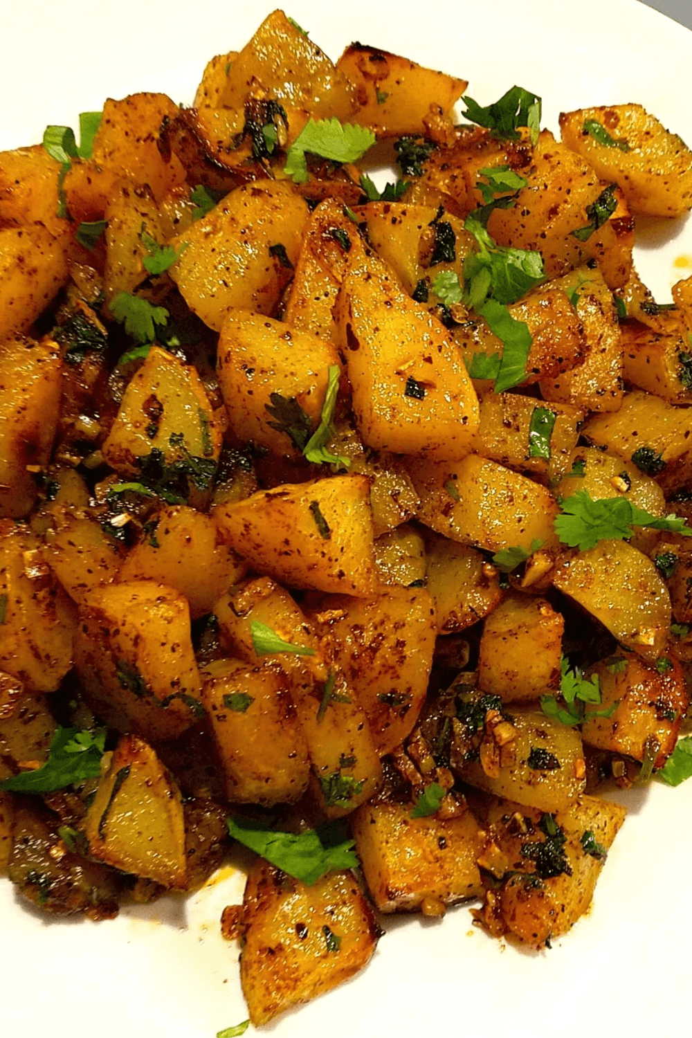 Batata Harra recipe with golden roasted potatoes, garlic, cilantro, and lemon