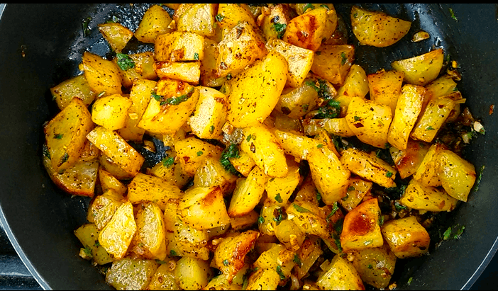 Crispy roasted potatoes tossed with garlic, red pepper flakes, paprika, and fresh cilantro