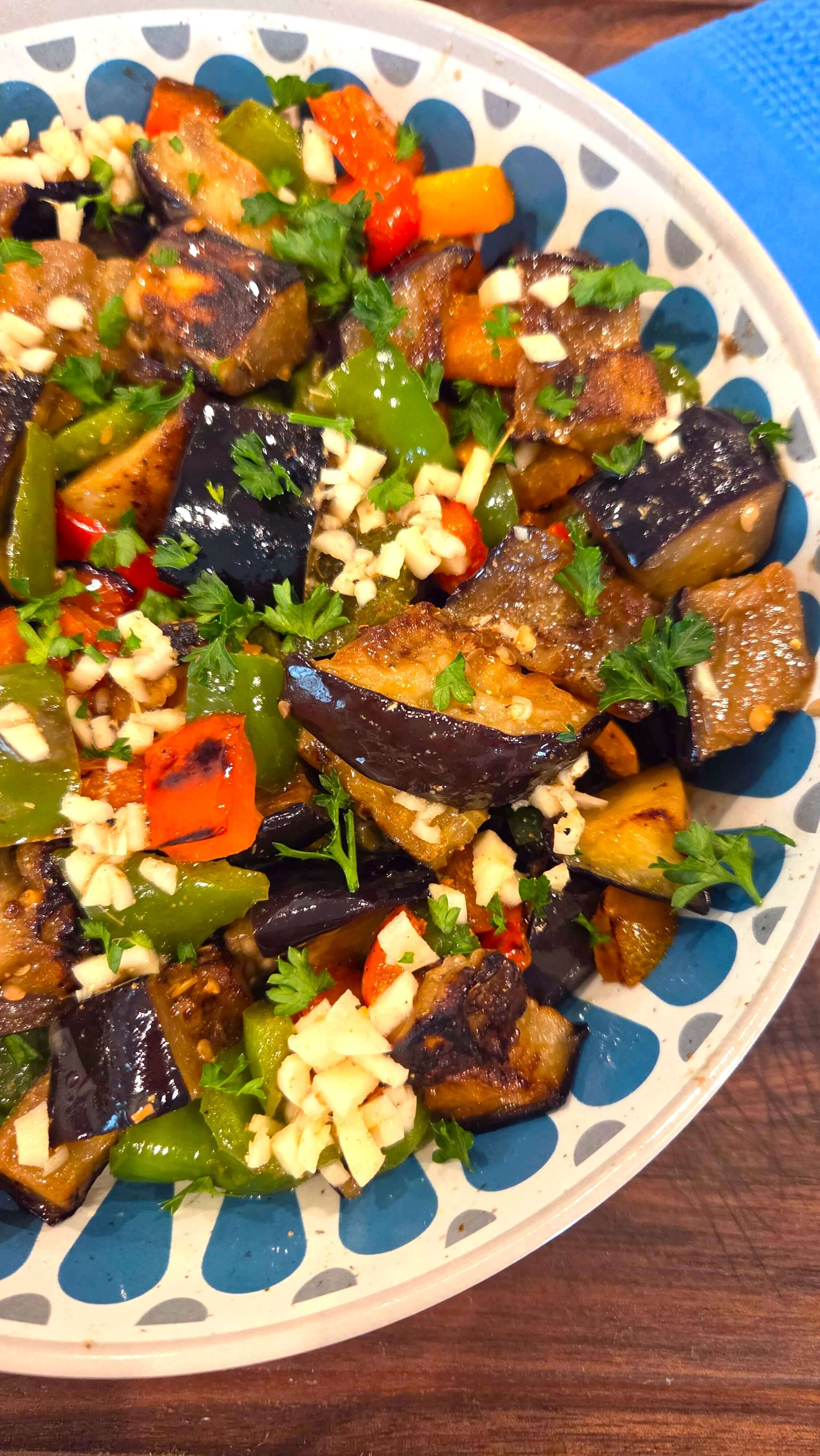 Homemade Egyptian eggplant salad with tender fried eggplant, peppers, parsley, and lemon garlic dressing.
