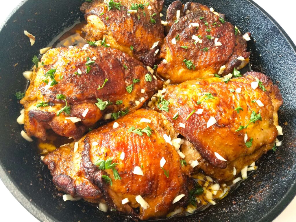 Crispy lemon garlic chicken thighs served with lemon-garlic pan juices and fresh parsley