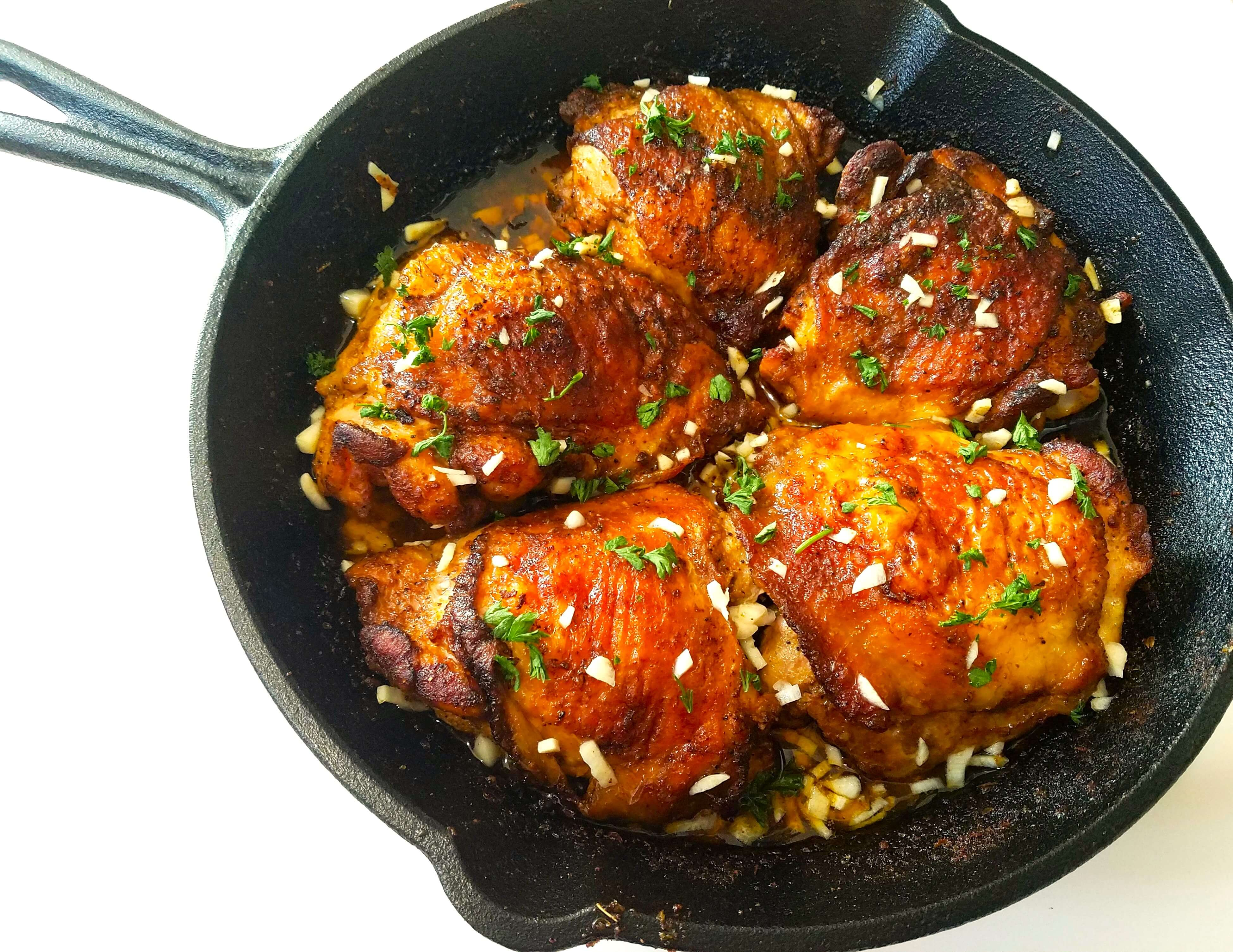 Juicy lemon garlic chicken thighs garnished with fresh parsley after cooking
